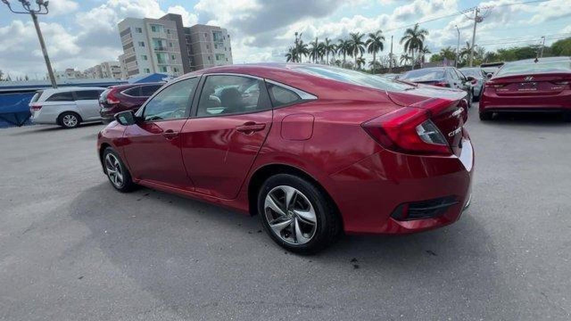2021 Red Honda Civic Sedan LX (2HGFC2F6XMH) with an 4 2.0 L engine, Variable transmission, located at 27610 S Dixie Hwy, Homestead, FL, 33032, (305) 749-2348, 25.510241, -80.438301 - Only 25,847 Miles! Scores 38 Highway MPG and 30 City MPG! This Honda Civic Sedan boasts a Regular Unleaded I-4 2.0 L/122 engine powering this Variable transmission. Window Grid Antenna, Wheels: 16 w/Full Covers, Vehicle Stability Assist (VSA) Electronic Stability Control (ESC).*This Honda Civic Seda - Photo#2