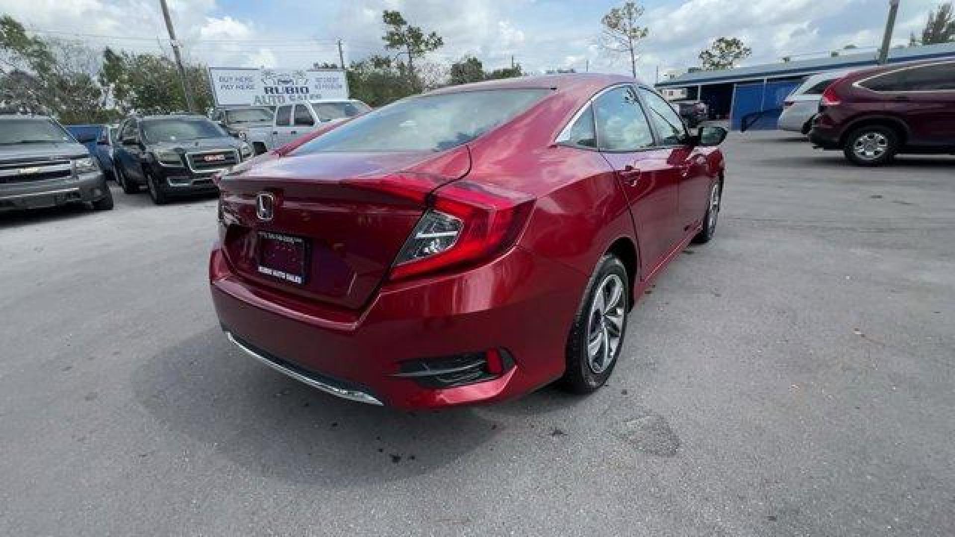 2021 Red Honda Civic Sedan LX (2HGFC2F6XMH) with an 4 2.0 L engine, Variable transmission, located at 27610 S Dixie Hwy, Homestead, FL, 33032, (305) 749-2348, 25.510241, -80.438301 - Only 25,847 Miles! Scores 38 Highway MPG and 30 City MPG! This Honda Civic Sedan boasts a Regular Unleaded I-4 2.0 L/122 engine powering this Variable transmission. Window Grid Antenna, Wheels: 16 w/Full Covers, Vehicle Stability Assist (VSA) Electronic Stability Control (ESC).*This Honda Civic Seda - Photo#4