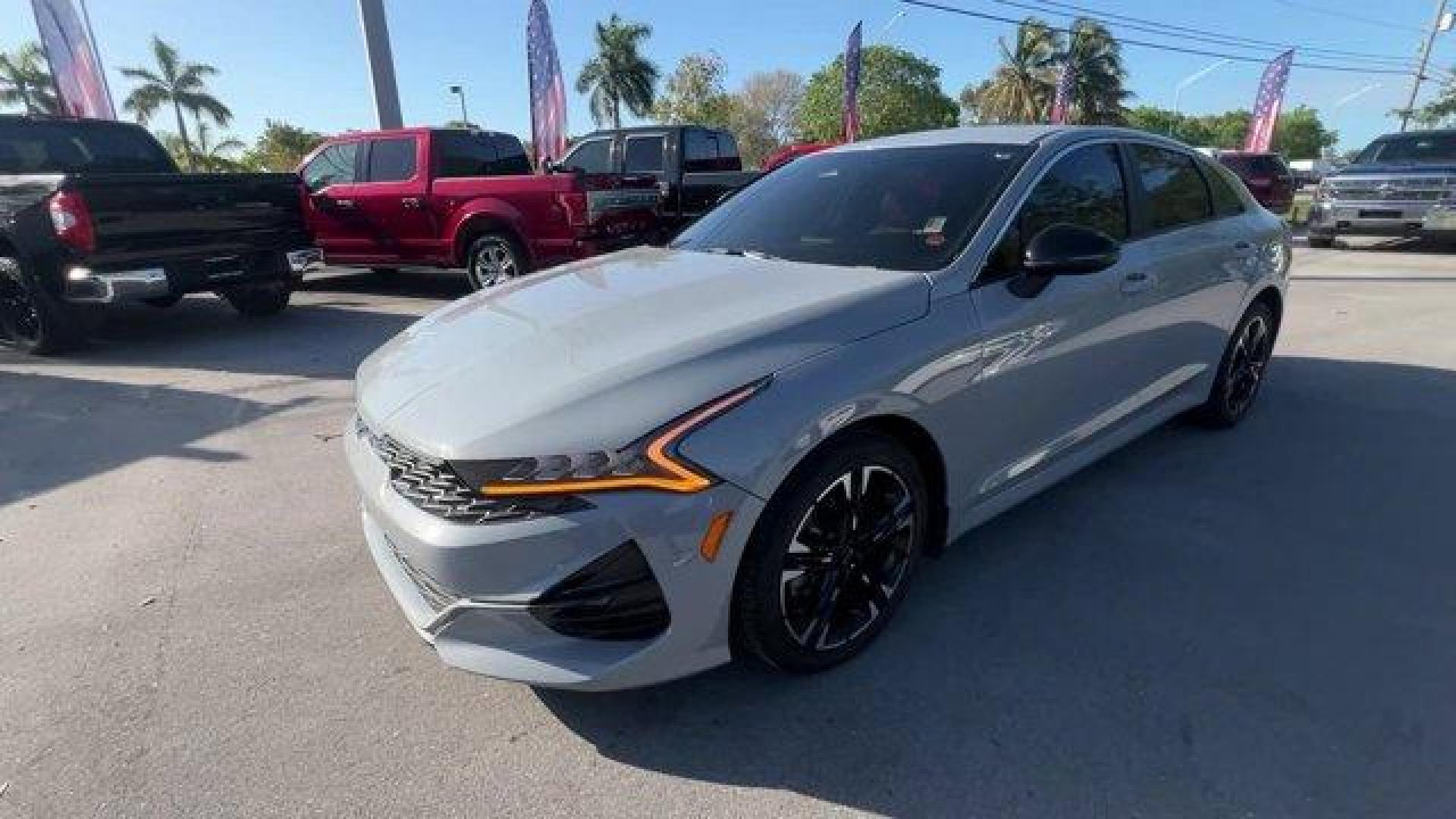 2021 Wolf Gray /Black Kia K5 GT-Line (5XXG64J24MG) with an 4 1.6 L engine, Automatic transmission, located at 27610 S Dixie Hwy, Homestead, FL, 33032, (305) 749-2348, 25.510241, -80.438301 - Only 35,083 Miles! Boasts 37 Highway MPG and 27 City MPG! This Kia K5 delivers a Intercooled Turbo Regular Unleaded I-4 1.6 L/98 engine powering this Automatic transmission. WOLF GRAY, GT-LINE RED INTERIOR PACKAGE, CARPETED FLOOR MATS.*This Kia K5 Comes Equipped with These Options *Window Grid Anten - Photo#0