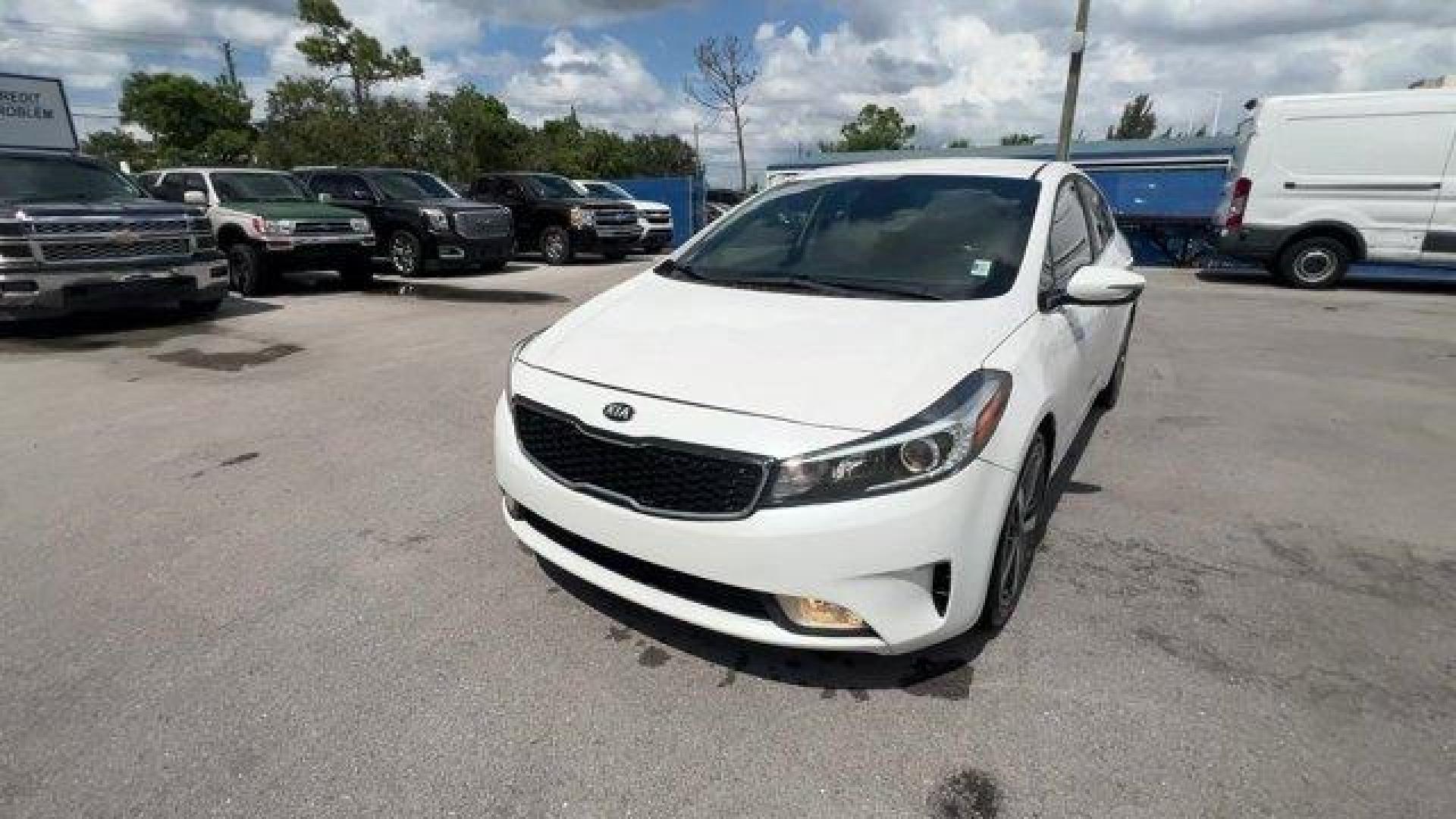 2017 Snow White Pearl /Black Kia Forte (3KPFL4A80HE) with an 4 2.0 L engine, Automatic transmission, located at 27610 S Dixie Hwy, Homestead, FL, 33032, (305) 749-2348, 25.510241, -80.438301 - KBB.com 10 Most Awarded Brands. Only 79,834 Miles! Scores 33 Highway MPG and 25 City MPG! This Kia Forte delivers a Regular Unleaded I-4 2.0 L/122 engine powering this Automatic transmission. SNOW WHITE PEARL, CARPETED FLOOR MATS, BLACK, LEATHER SEAT TRIM.*This Kia Forte Comes Equipped with These Op - Photo#0