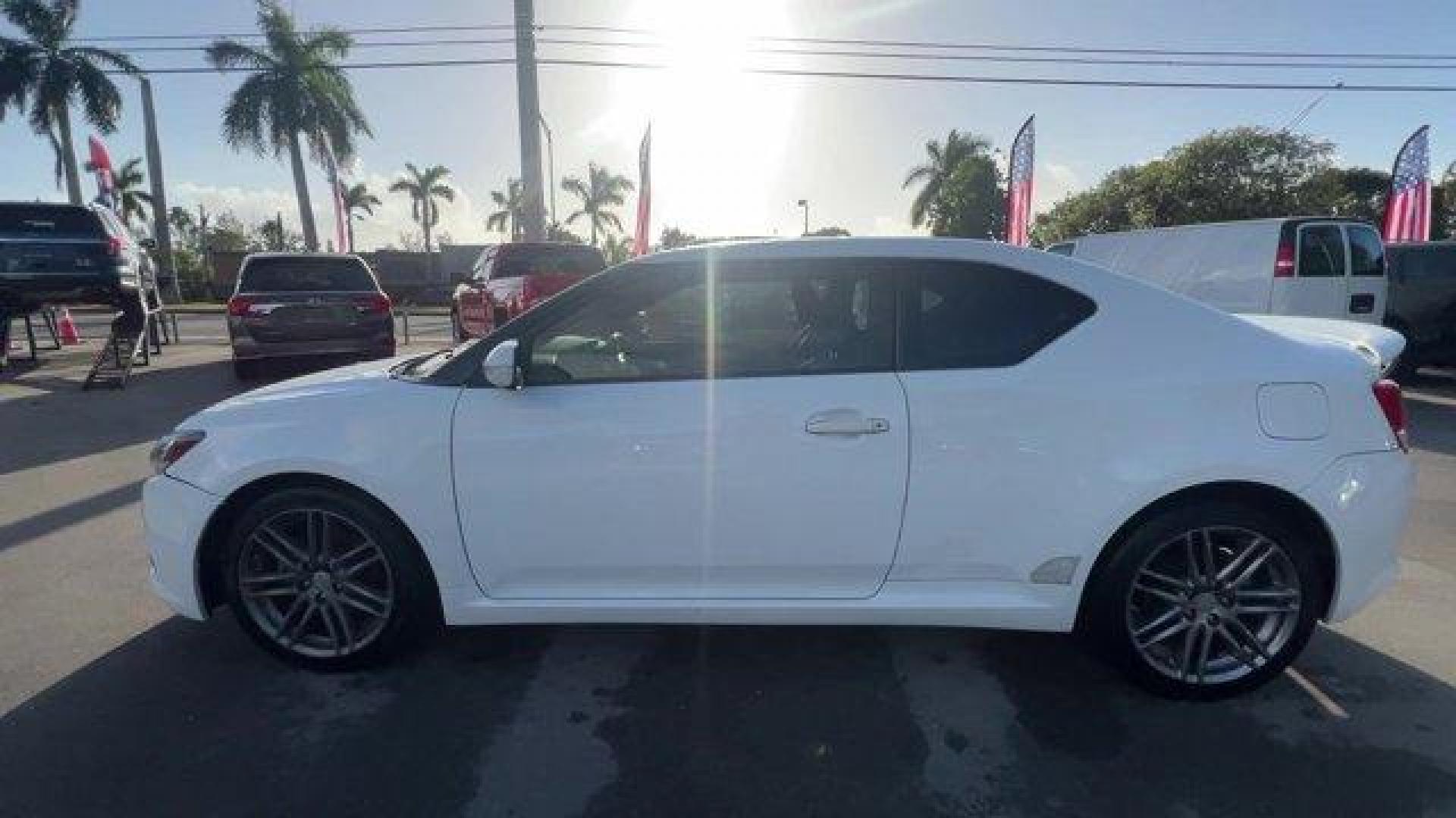 2013 White Scion tC (JTKJF5C75D3) with an 4 2.5L engine, Automatic transmission, located at 27610 S Dixie Hwy, Homestead, FL, 33032, (305) 749-2348, 25.510241, -80.438301 - IIHS Top Safety Pick. Only 122,737 Miles! Scores 31 Highway MPG and 23 City MPG! This Scion tC boasts a Gas I4 2.5L/152 engine powering this Automatic transmission. Vehicle stability control (VSC), Variable intermittent windshield wipers, Traction control.* This Scion tC Features the Following Optio - Photo#1