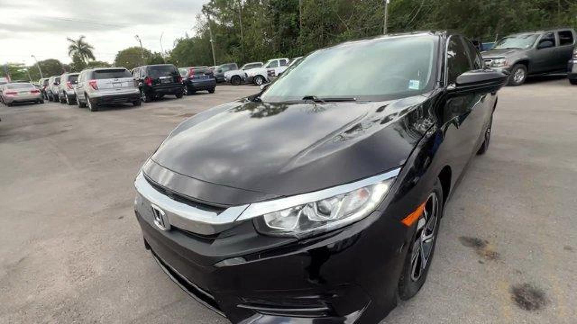 2017 Black Honda Civic Sedan LX (19XFC2F56HE) with an 4 2.0 L engine, Variable transmission, located at 27610 S Dixie Hwy, Homestead, FL, 33032, (305) 749-2348, 25.510241, -80.438301 - IIHS Top Safety Pick. Delivers 40 Highway MPG and 31 City MPG! This Honda Civic Sedan delivers a Regular Unleaded I-4 2.0 L/122 engine powering this Variable transmission. Wheels: 16 w/Full Covers, VSA Electronic Stability Control (ESC), Valet Function.*This Honda Civic Sedan Comes Equipped with The - Photo#0