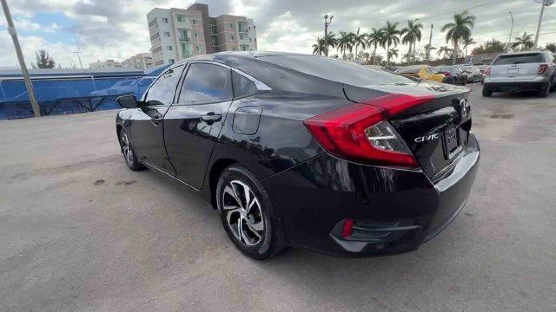 2017 Black Honda Civic Sedan LX (19XFC2F56HE) with an 4 2.0 L engine, Variable transmission, located at 27610 S Dixie Hwy, Homestead, FL, 33032, (305) 749-2348, 25.510241, -80.438301 - IIHS Top Safety Pick. Delivers 40 Highway MPG and 31 City MPG! This Honda Civic Sedan delivers a Regular Unleaded I-4 2.0 L/122 engine powering this Variable transmission. Wheels: 16 w/Full Covers, VSA Electronic Stability Control (ESC), Valet Function.*This Honda Civic Sedan Comes Equipped with The - Photo#1