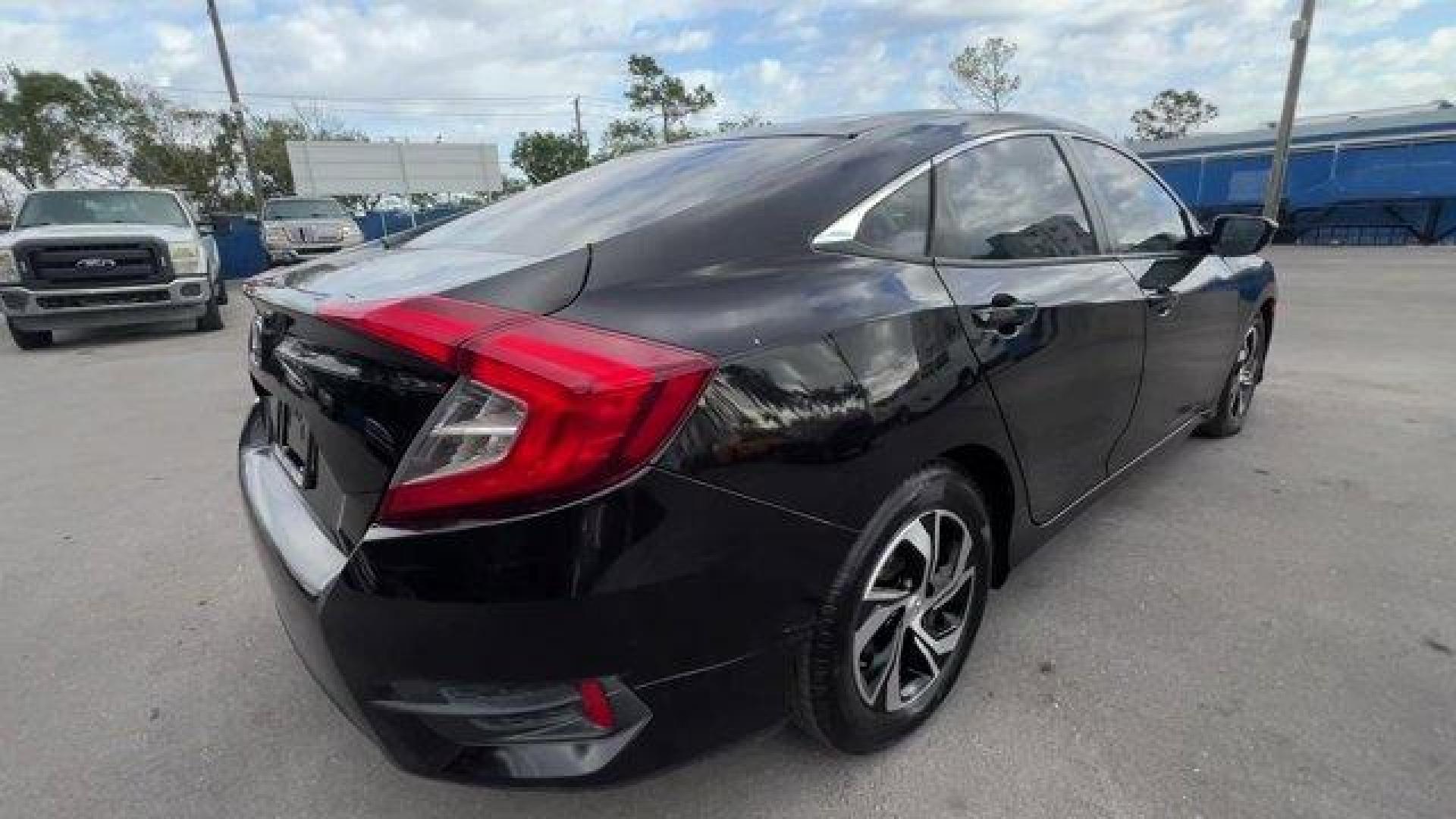 2017 Black Honda Civic Sedan LX (19XFC2F56HE) with an 4 2.0 L engine, Variable transmission, located at 27610 S Dixie Hwy, Homestead, FL, 33032, (305) 749-2348, 25.510241, -80.438301 - IIHS Top Safety Pick. Delivers 40 Highway MPG and 31 City MPG! This Honda Civic Sedan delivers a Regular Unleaded I-4 2.0 L/122 engine powering this Variable transmission. Wheels: 16 w/Full Covers, VSA Electronic Stability Control (ESC), Valet Function.*This Honda Civic Sedan Comes Equipped with The - Photo#2