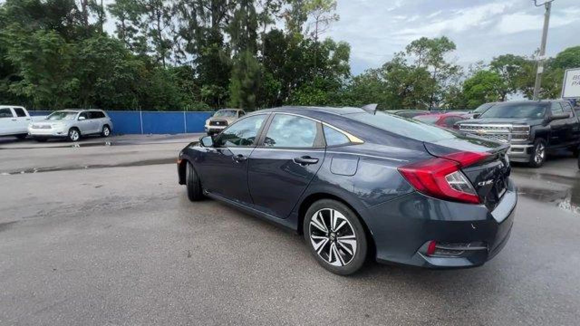 2016 Gray Honda Civic Sedan EX-T (19XFC1F30GE) with an 4 1.5 L engine, Variable transmission, located at 27610 S Dixie Hwy, Homestead, FL, 33032, (305) 749-2348, 25.510241, -80.438301 - IIHS Top Safety Pick+. Delivers 42 Highway MPG and 31 City MPG! This Honda Civic Sedan delivers a Intercooled Turbo Regular Unleaded I-4 1.5 L/91 engine powering this Variable transmission. Wheels: 17 Alloy, Wheels w/Silver Accents, VSA Electronic Stability Control (ESC).*This Honda Civic Sedan Come - Photo#2